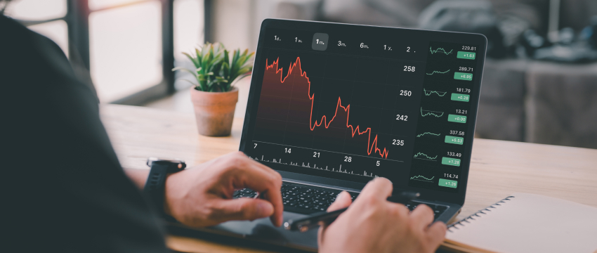 Laptop screen displaying a stock market chart on Metatrader 4 with various market trends and performance metrics for mt4 speed